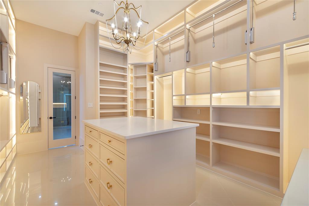 4222 Middleton Road Dallas, TX 75229 - Photo 22 of 40 a spacious bathroom with a double vanity sink a large mirror and shower