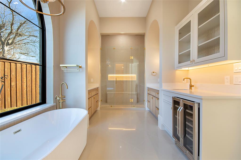 4222 Middleton Road Dallas, TX 75229 - Photo 24 of 40 a bathroom with a tub a sink and a large mirror