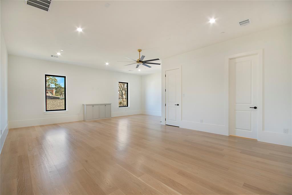 4222 Middleton Road Dallas, TX 75229 - Photo 34 of 40 a view of a livingroom with wooden floor and a ceiling fan