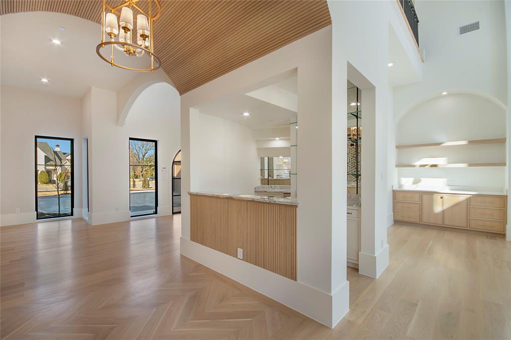 4222 Middleton Road Dallas, TX 75229 - Photo 6 of 40 a view of a hallway with wooden floor and a kitchen