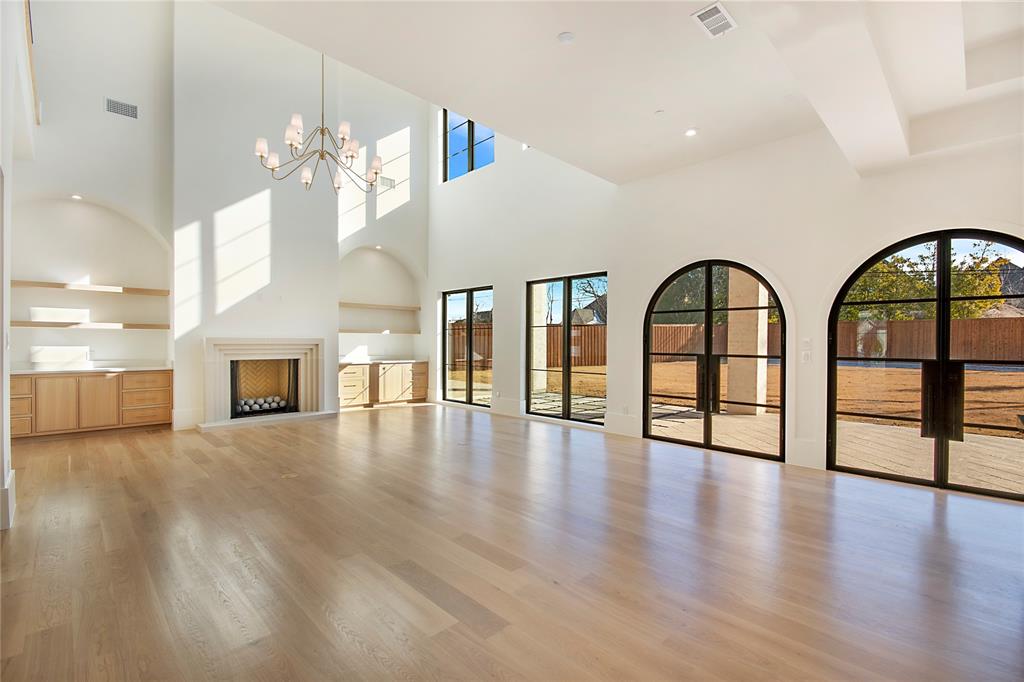4222 Middleton Road Dallas, TX 75229 - Photo 9 of 40 a view of an empty room with wooden floor and a fireplace