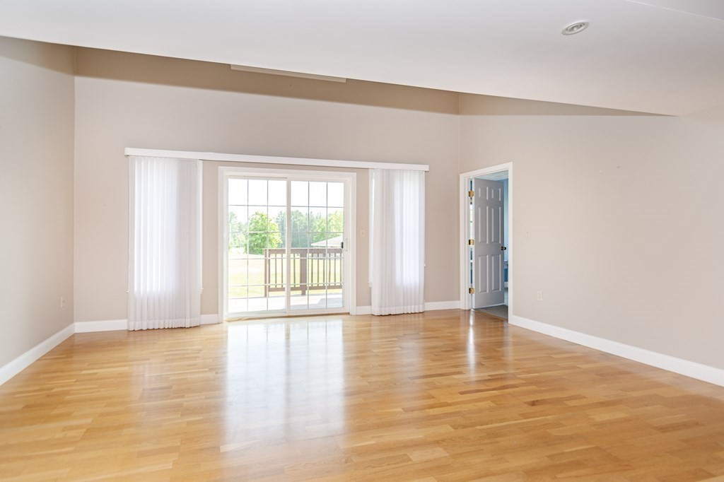 53 Baldwin Road, Unit 403 Billerica, MA 01821 - Photo 13 of 40 a view of an empty room with wooden floor and a window