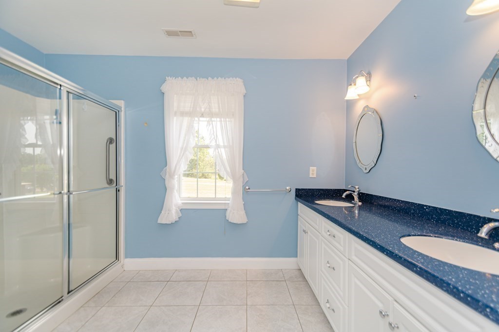 53 Baldwin Road, Unit 403 Billerica, MA 01821 - Photo 17 of 40 a spacious bathroom with a double vanity sink and a mirror