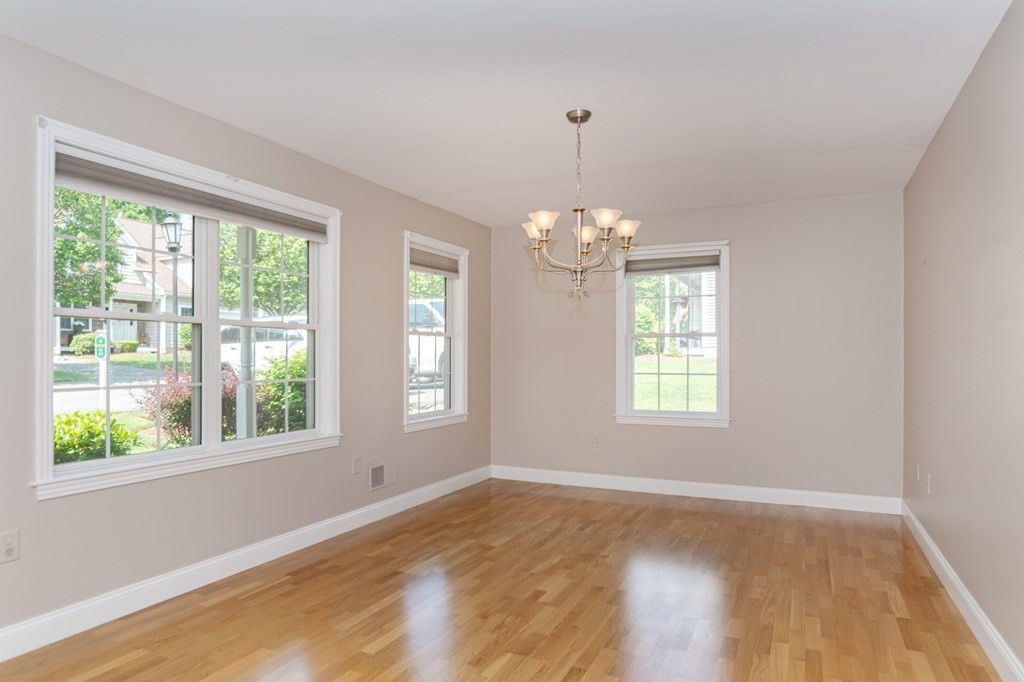 53 Baldwin Road, Unit 403 Billerica, MA 01821 - Photo 2 of 40 a view of an empty room with wooden floor and a window