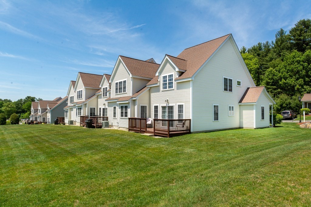 53 Baldwin Road, Unit 403 Billerica, MA 01821 - Photo 34 of 40 a view of a house with a big yard and large trees