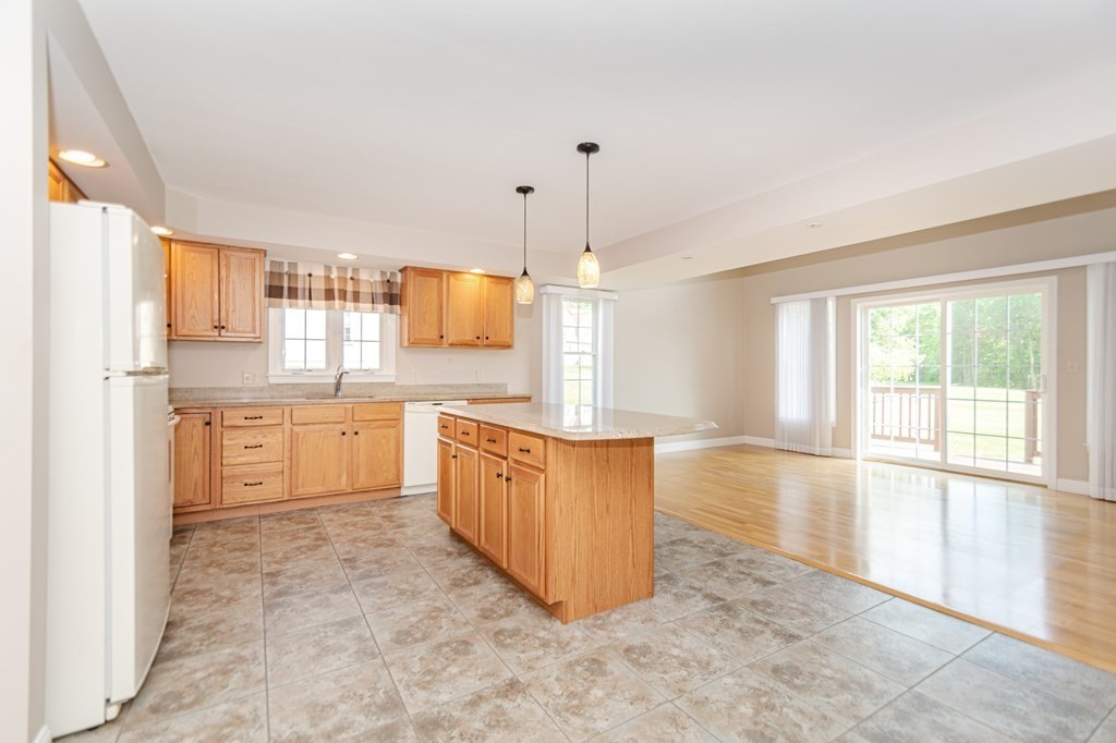 53 Baldwin Road, Unit 403 Billerica, MA 01821 - Photo 6 of 40 a large kitchen with stainless steel appliances a stove a sink a refrigerator and white cabinets with wooden floor