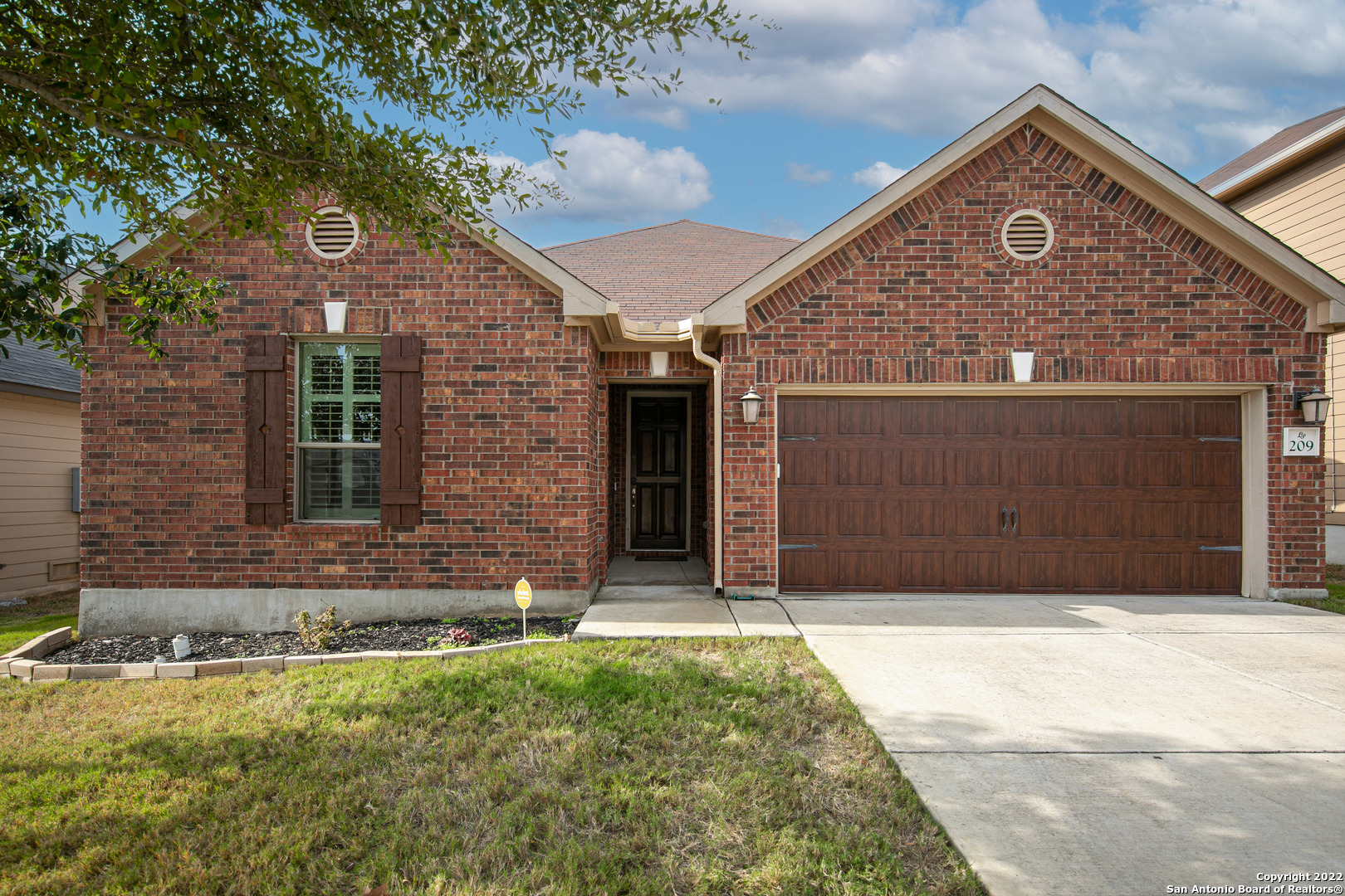 a front view of a house with a yard