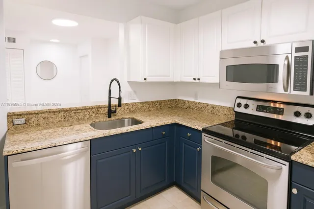 a kitchen with a sink stove and cabinets