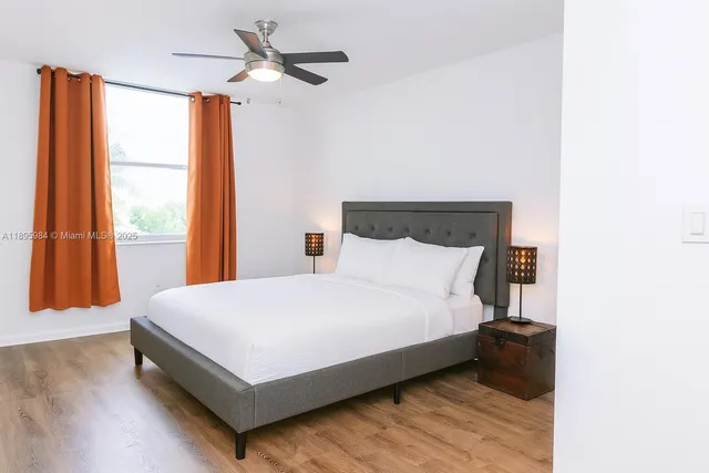 a large bed sitting in a bedroom next to a window