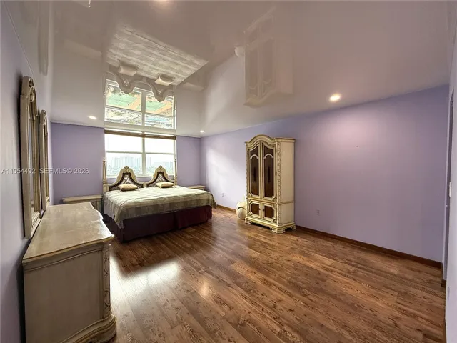 a bedroom with bed and window