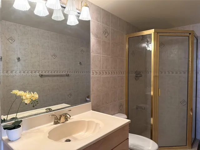 a bathroom with a sink toilet and shower