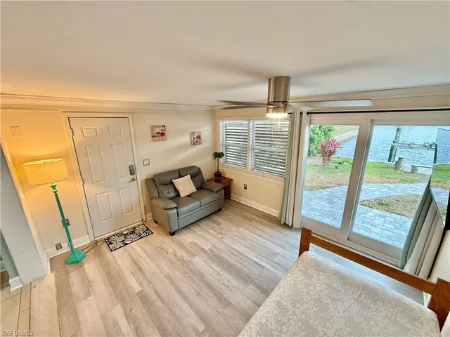 a living room with furniture and a floor to ceiling window