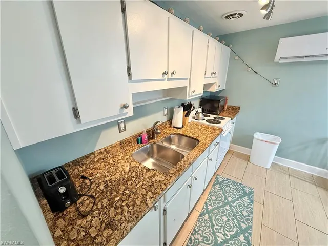 a kitchen with a sink stove and cabinets