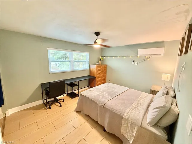 a bedroom with a bed and a table in it