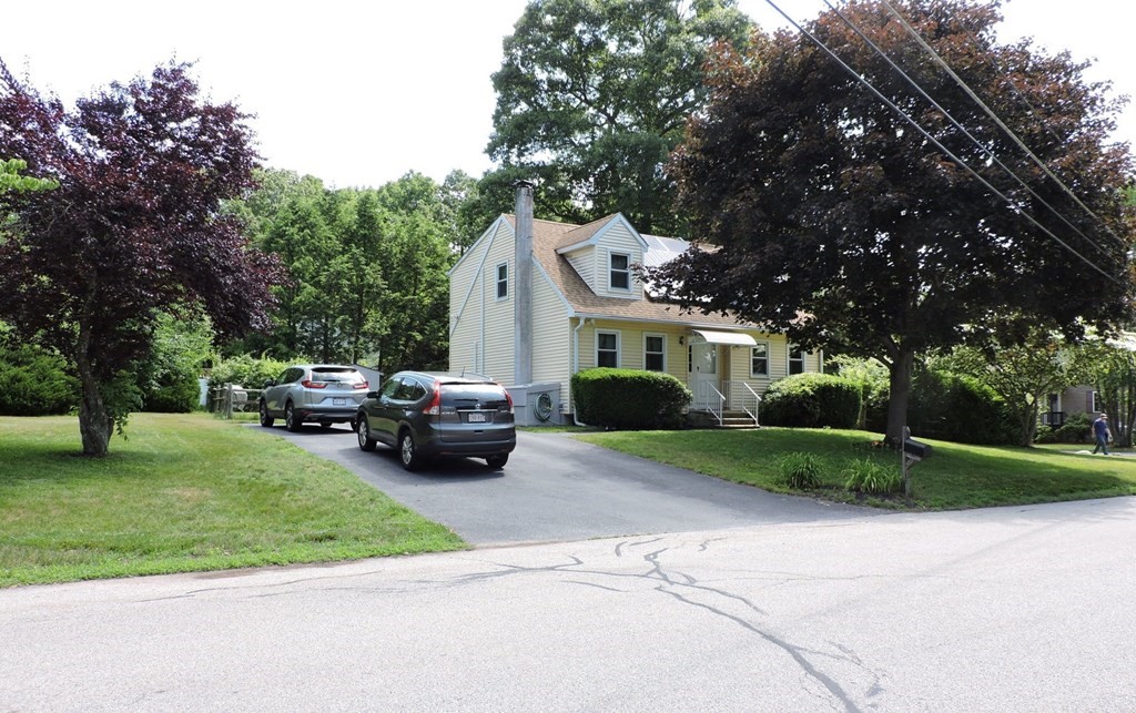 2 Hall Road Webster, MA 01570 - Photo 1 of 42 a front view of a house with a garden and trees