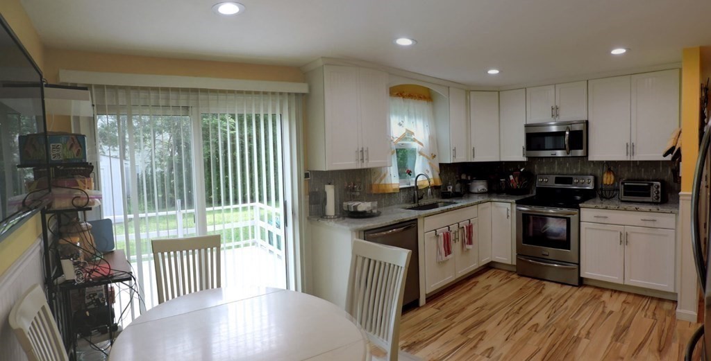 2 Hall Road Webster, MA 01570 - Photo 11 of 42 a kitchen with stainless steel appliances granite countertop a stove a sink and a refrigerator