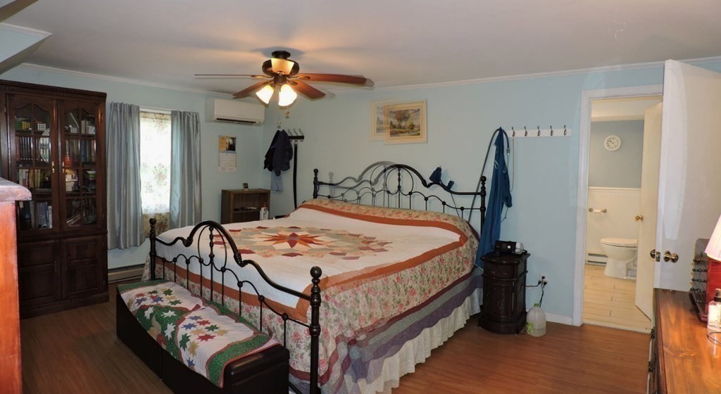 2 Hall Road Webster, MA 01570 - Photo 25 of 42 a bed sitting in a bedroom next to a window