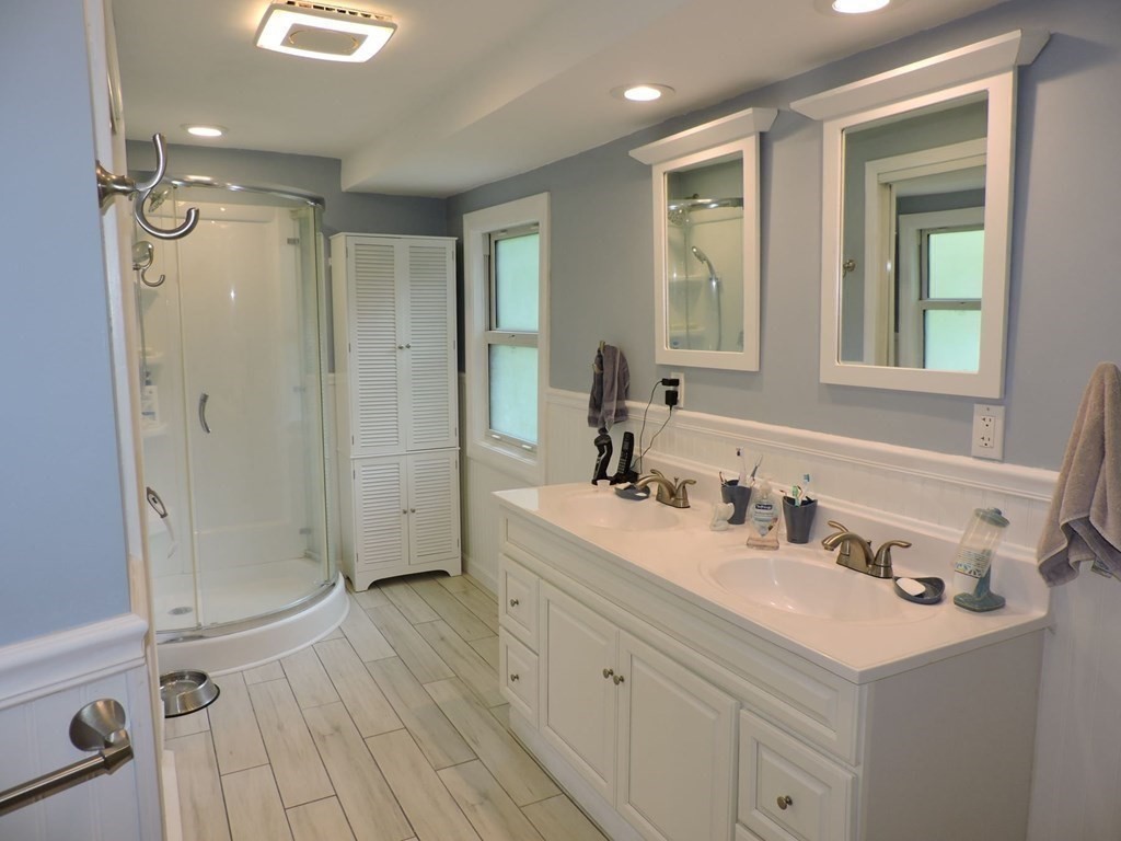 2 Hall Road Webster, MA 01570 - Photo 28 of 42 a bathroom with a sink a mirror a vanity and a shower