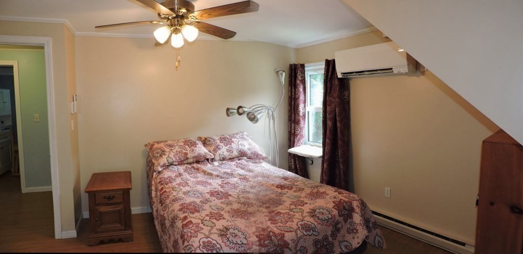 2 Hall Road Webster, MA 01570 - Photo 29 of 42 a bedroom with a bed and a chandelier
