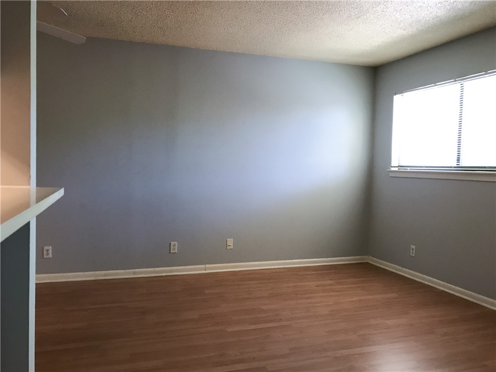 5001 Bull Creek Road, Unit 116 Austin, TX 78731 - Photo 3 of 13 a room with wooden floor and windows