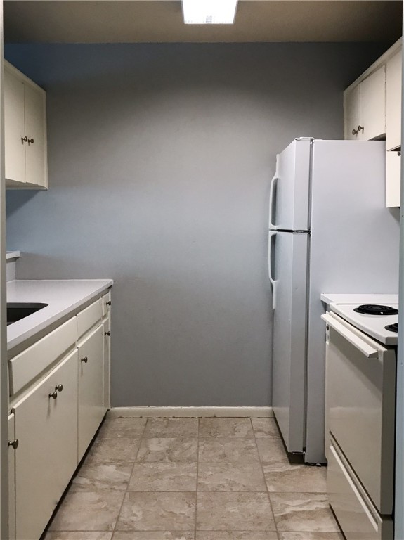 5001 Bull Creek Road, Unit 116 Austin, TX 78731 - Photo 9 of 13 a kitchen with a refrigerator and a sink