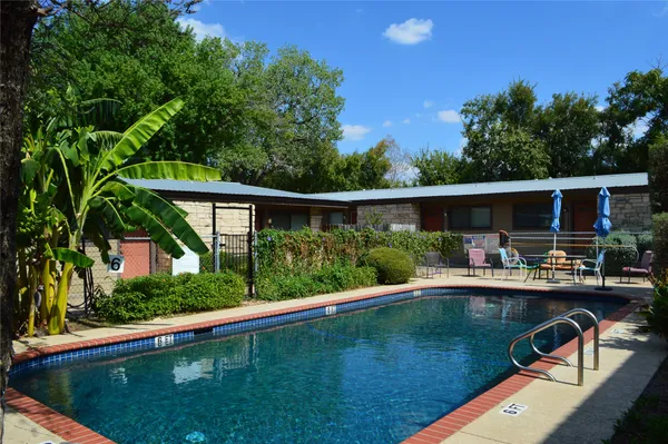 a view of a house with a flower garden