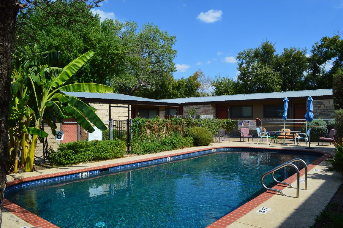 5001 Bull Creek Road, Unit 116 Austin, TX 78731 - Photo 10 of 13 a view of backyard with swimming pool and outdoor seating