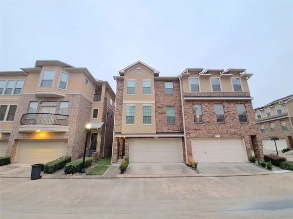 a front view of a residential apartment building with a yard