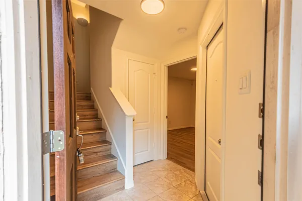 a view of a hallway with wooden floor and entryway