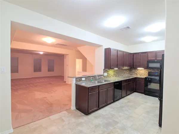 a kitchen with a stove and cabinets