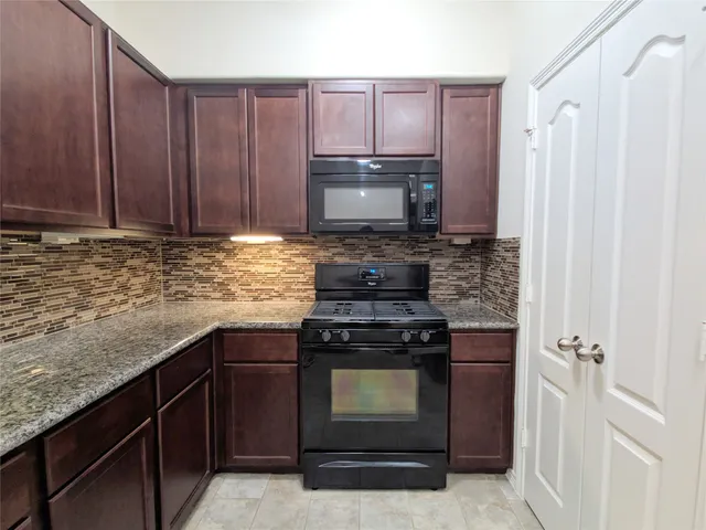 a kitchen with a stove and a sink