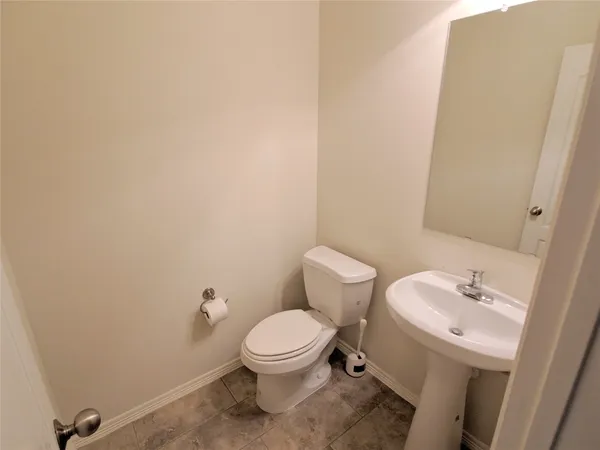 a white toilet sitting next to a bathroom sink