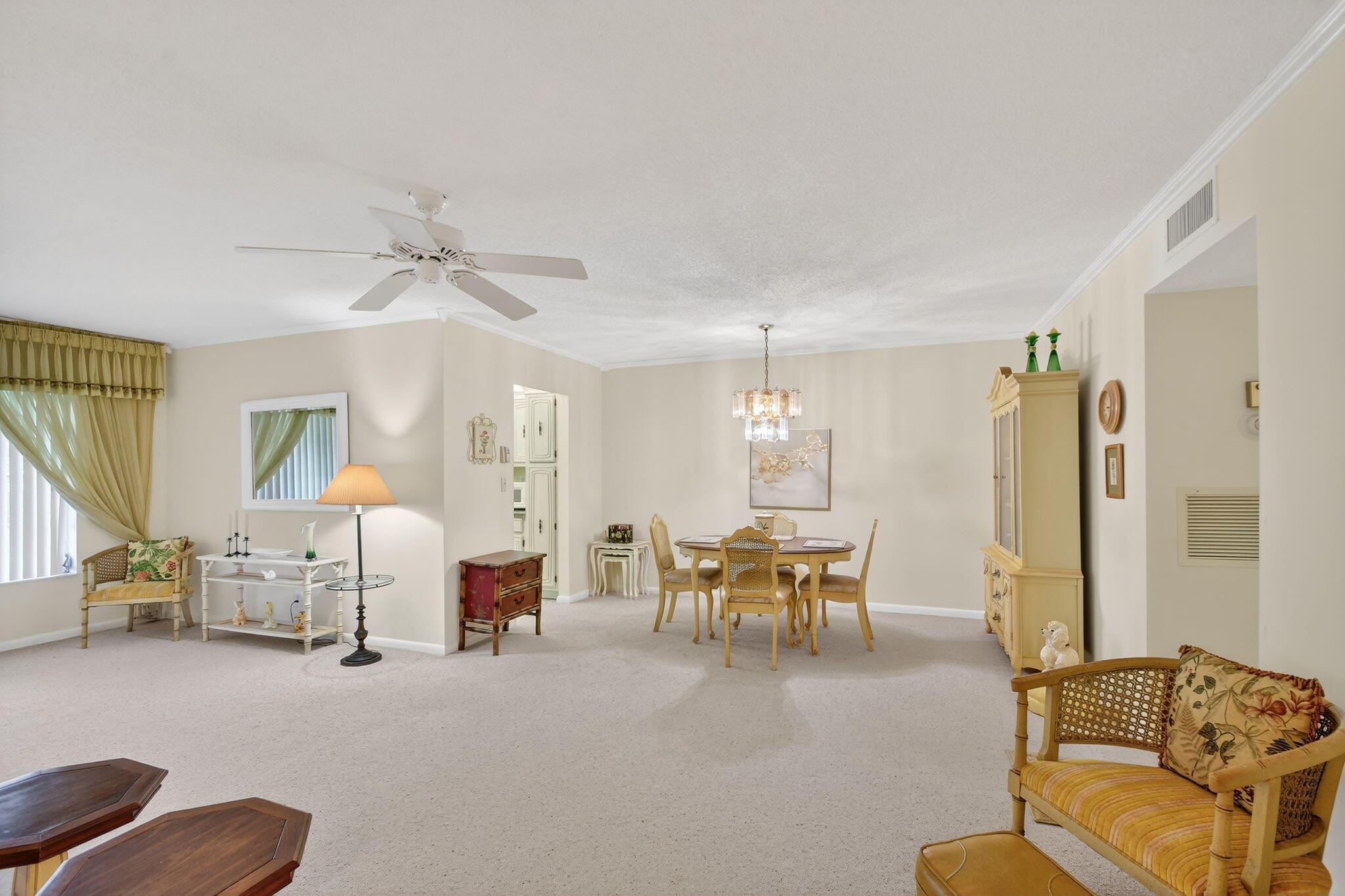 615 High Point Drive, Unit C Delray Beach, FL 33445 - Photo 12 of 48 a living room with furniture and a chandelier