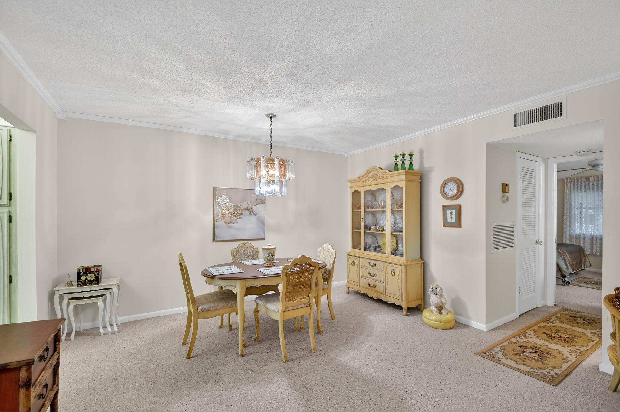 615 High Point Drive, Unit C Delray Beach, FL 33445 - Photo 14 of 48 a view of a dining room with furniture and chandelier