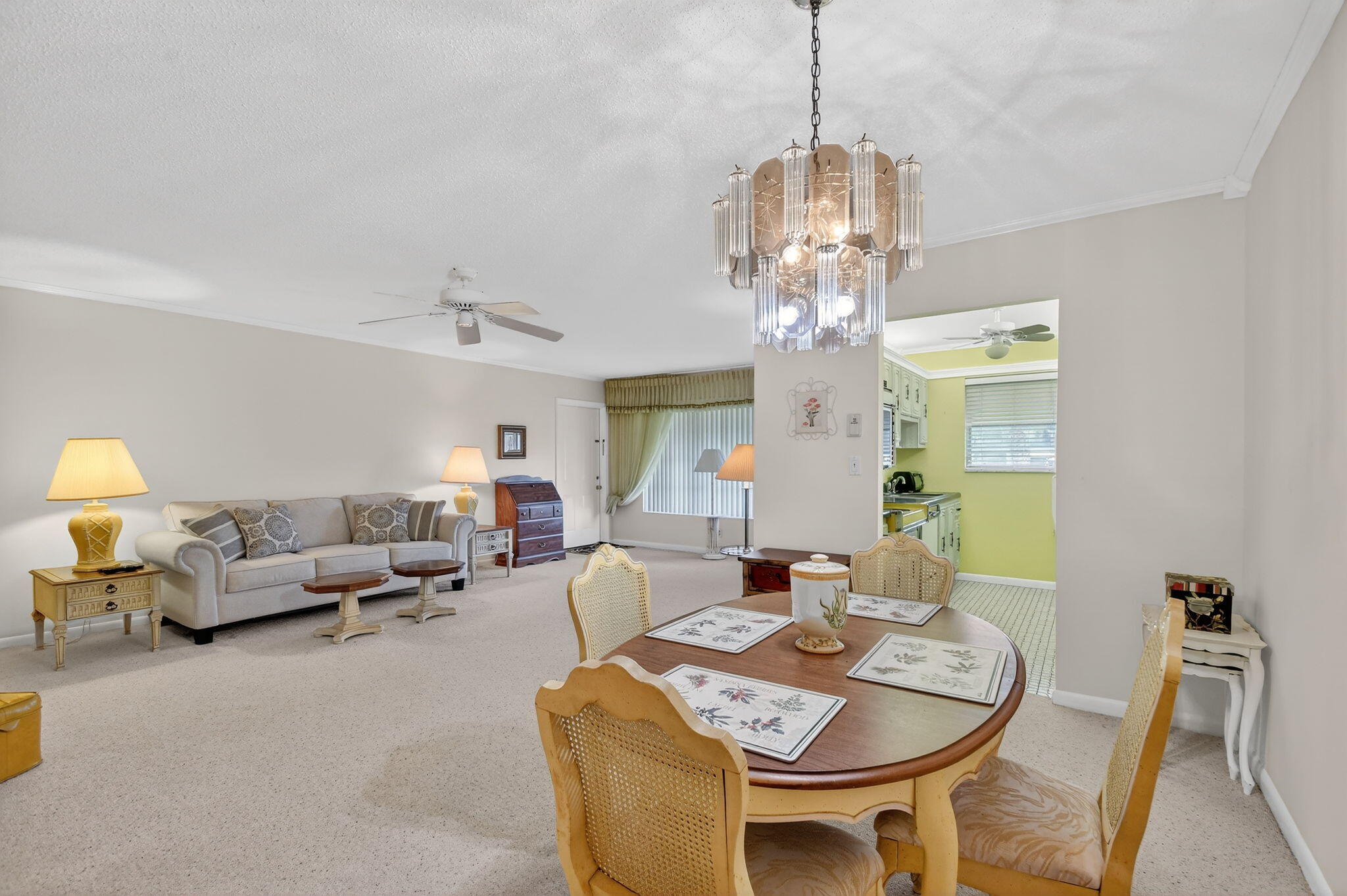 615 High Point Drive, Unit C Delray Beach, FL 33445 - Photo 15 of 48 a living room with furniture a chandelier and a chandelier