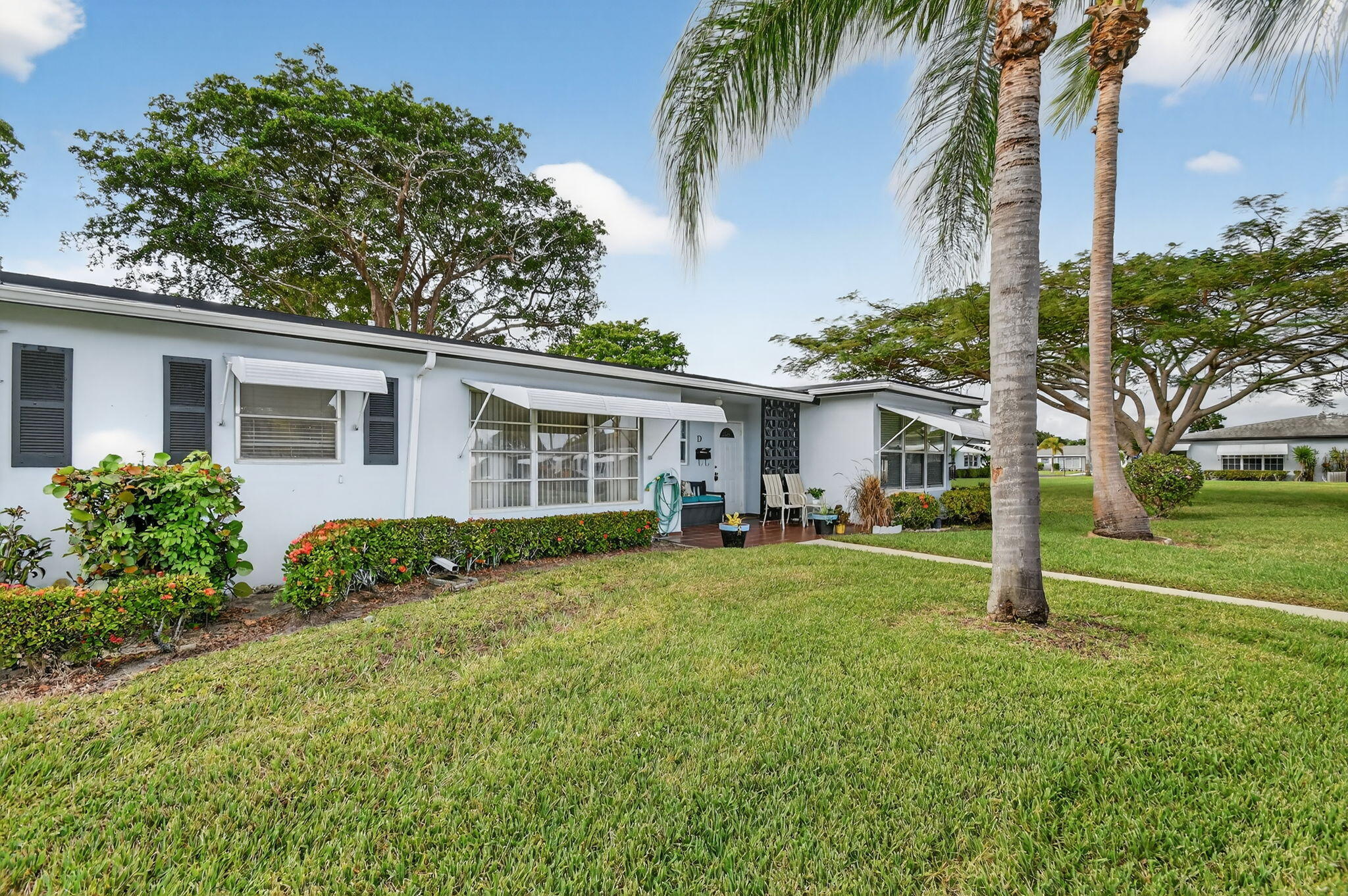 615 High Point Drive, Unit C Delray Beach, FL 33445 - Photo 2 of 48 a view of a house with backyard and a tree