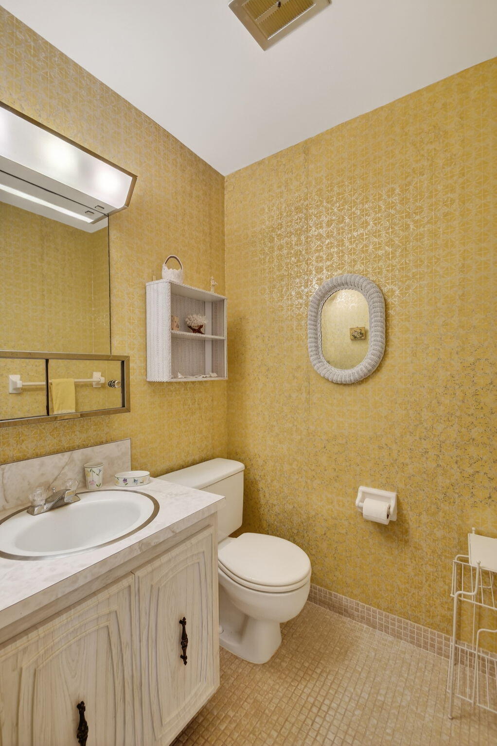 615 High Point Drive, Unit C Delray Beach, FL 33445 - Photo 21 of 48 a bathroom with a granite countertop toilet sink and mirror