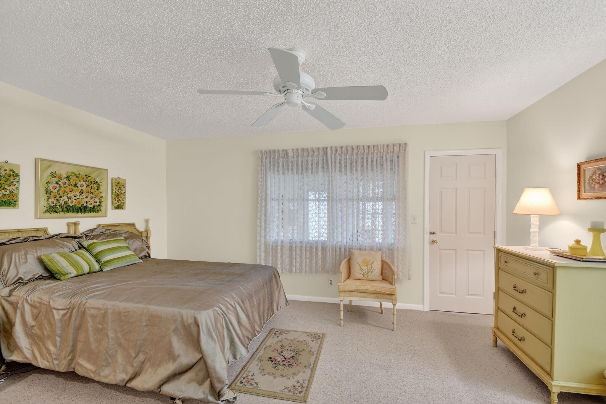 615 High Point Drive, Unit C Delray Beach, FL 33445 - Photo 22 of 48 a bedroom with a bed and a chandelier