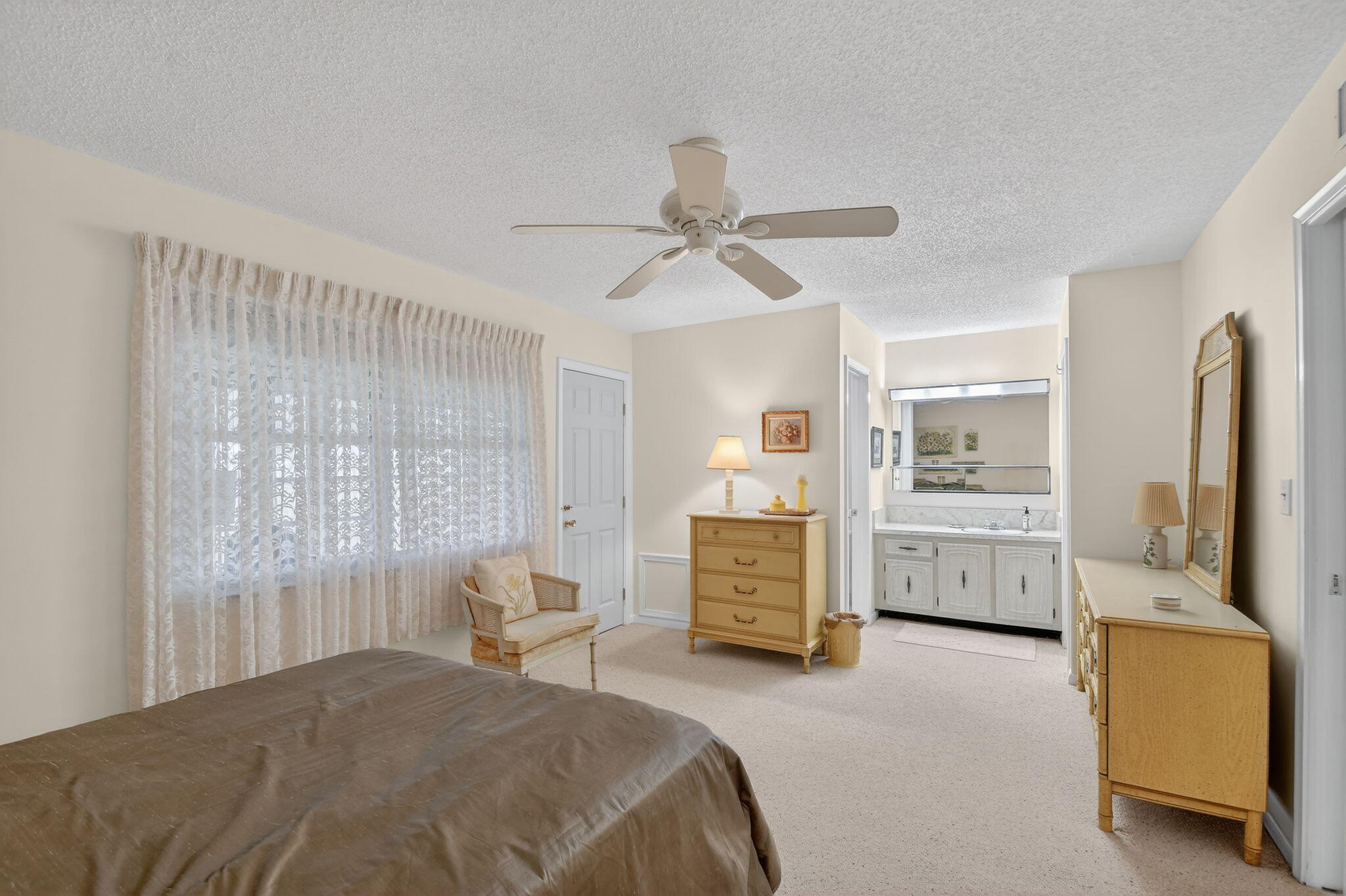 615 High Point Drive, Unit C Delray Beach, FL 33445 - Photo 23 of 48 a bedroom with a bed and a chandelier