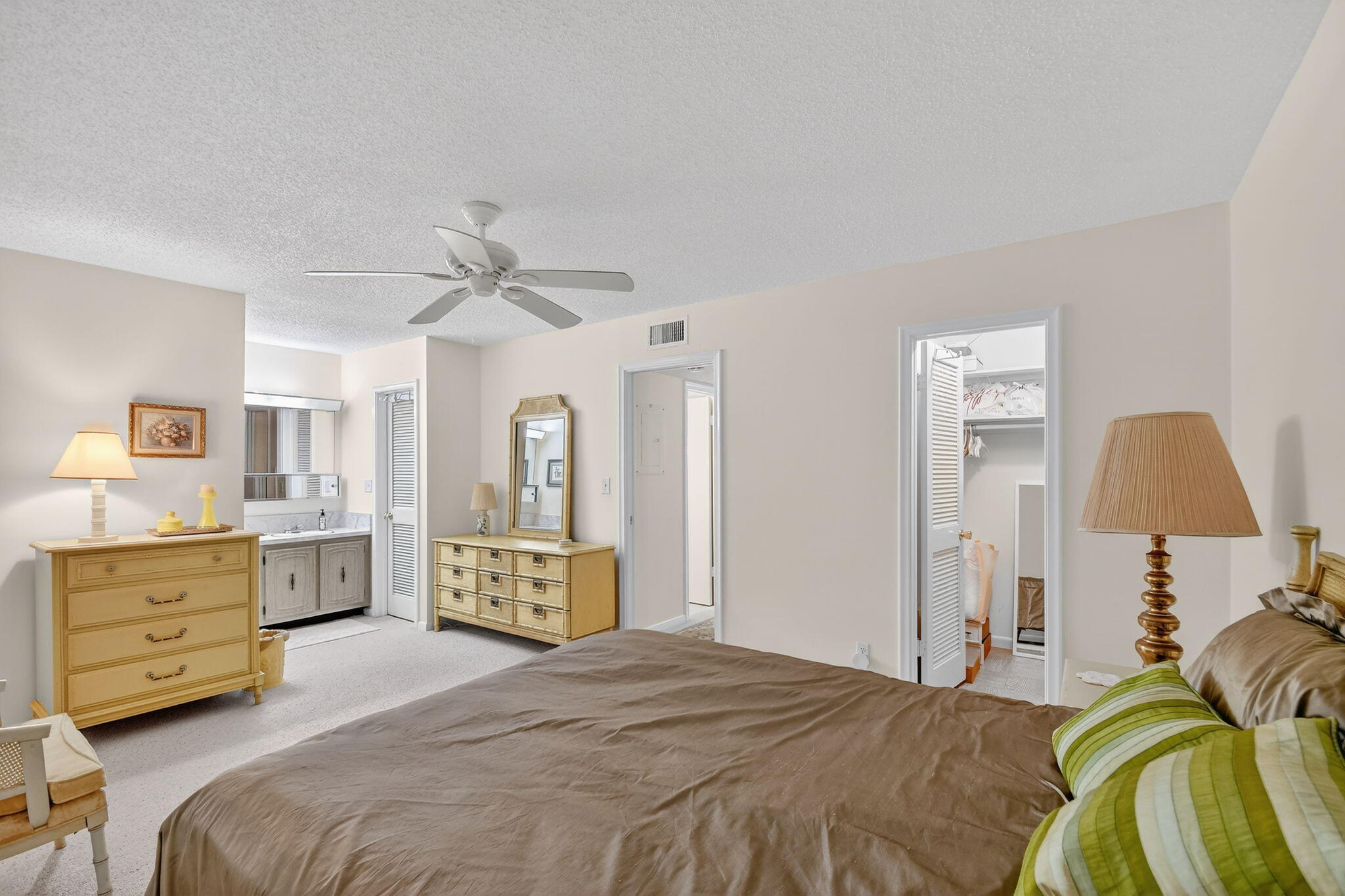 615 High Point Drive, Unit C Delray Beach, FL 33445 - Photo 24 of 48 a spacious bedroom with a bed and dresser