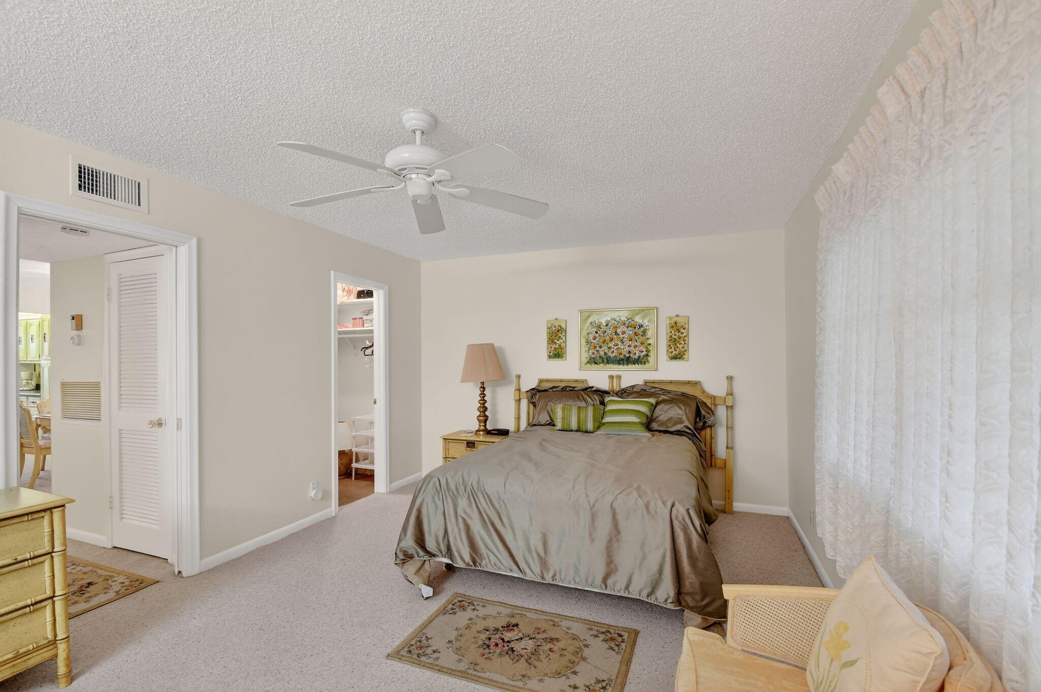 615 High Point Drive, Unit C Delray Beach, FL 33445 - Photo 25 of 48 a bedroom with furniture and a chandelier
