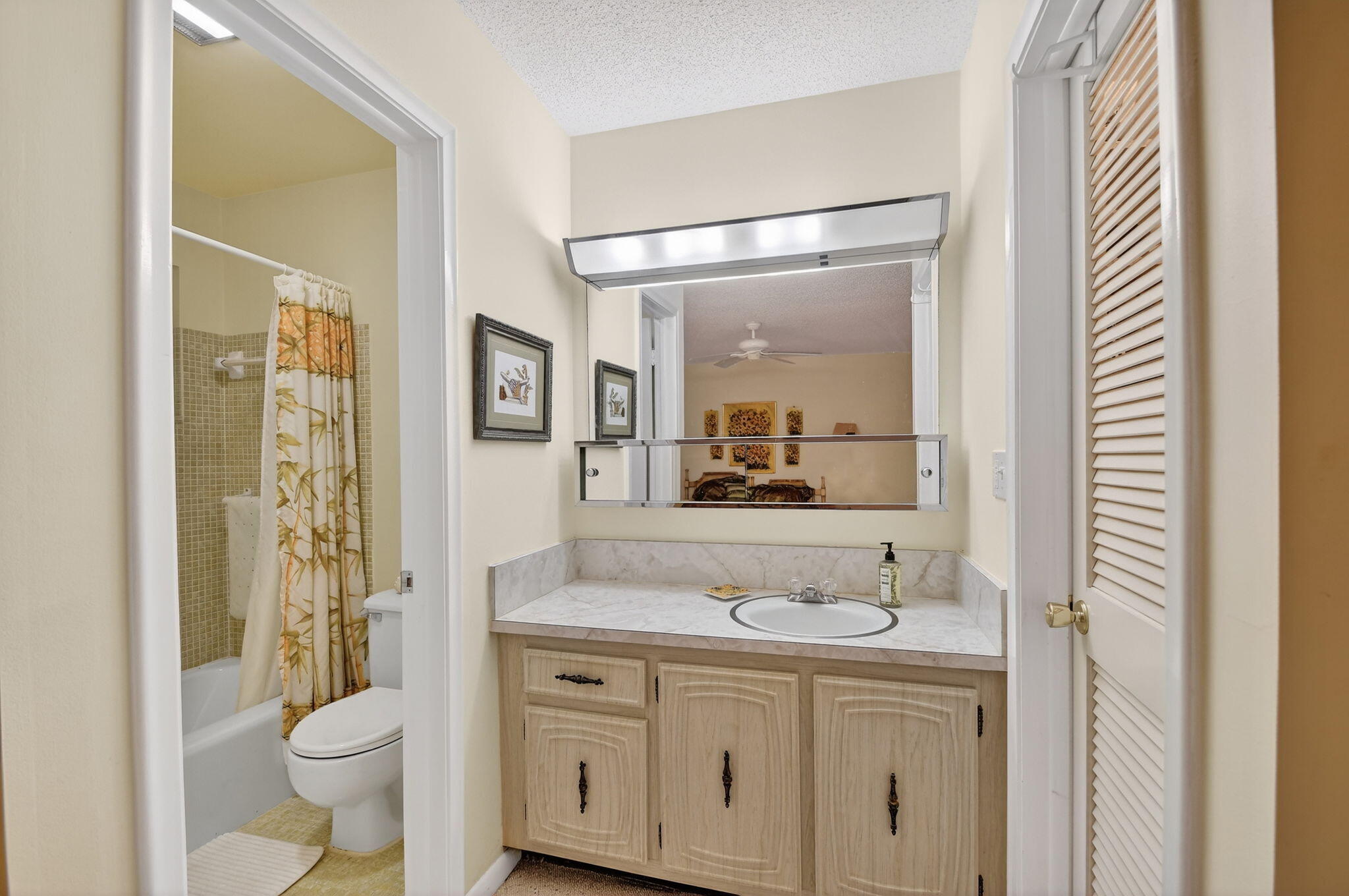 615 High Point Drive, Unit C Delray Beach, FL 33445 - Photo 26 of 48 a bathroom with a granite countertop sink toilet and shower