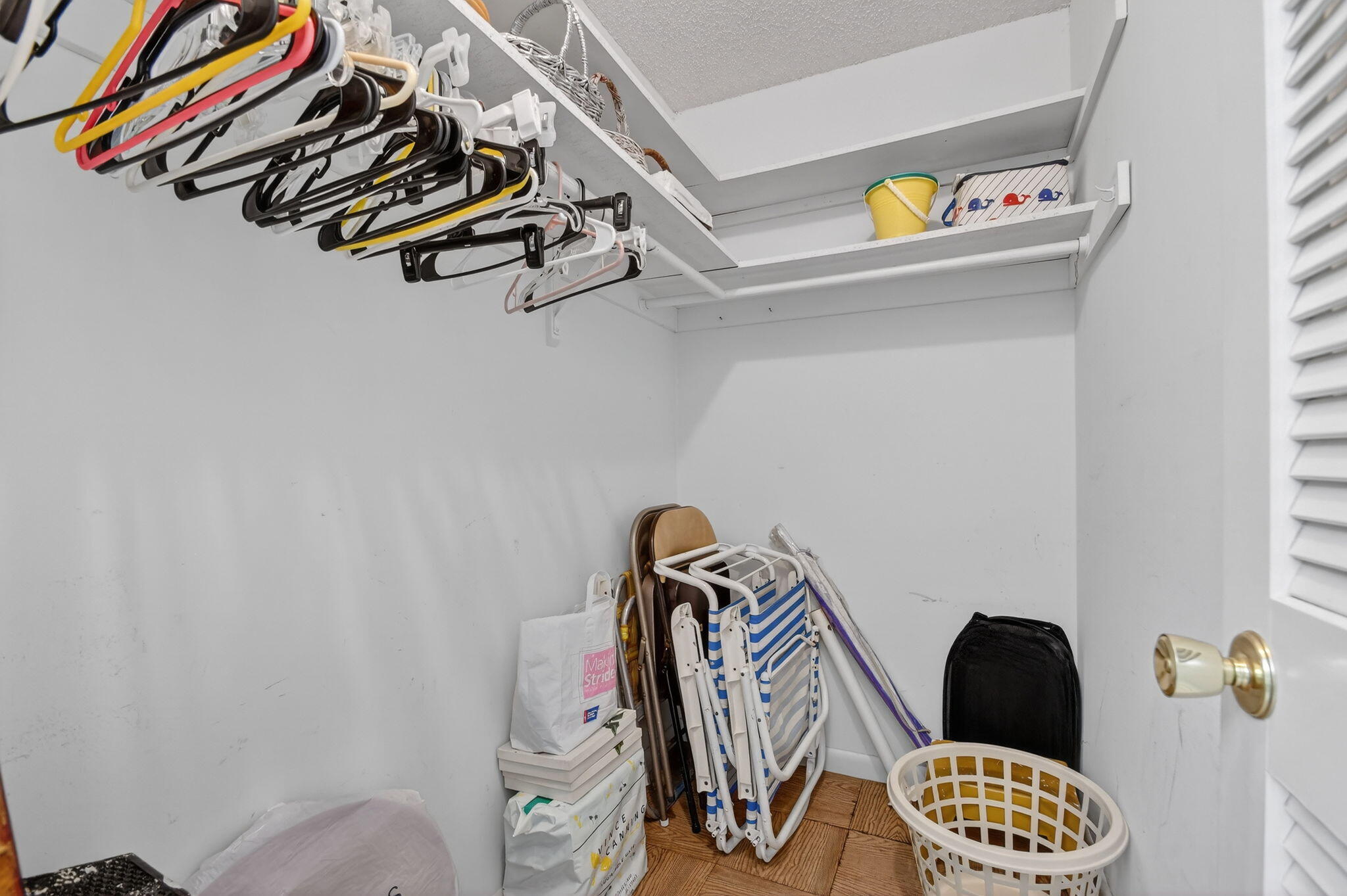 615 High Point Drive, Unit C Delray Beach, FL 33445 - Photo 29 of 48 a view of walk in closet with clothes and shoes