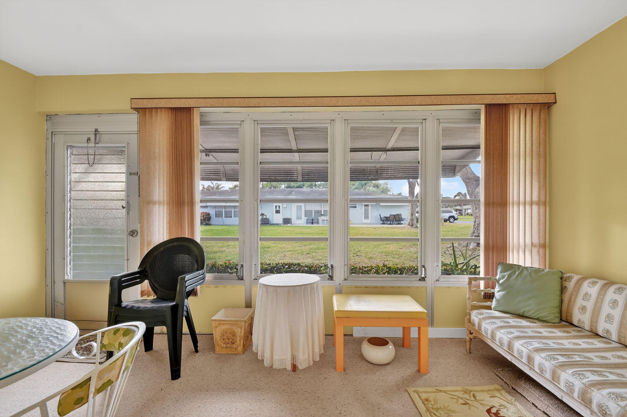 615 High Point Drive, Unit C Delray Beach, FL 33445 - Photo 31 of 48 a living room with furniture and a floor to ceiling window