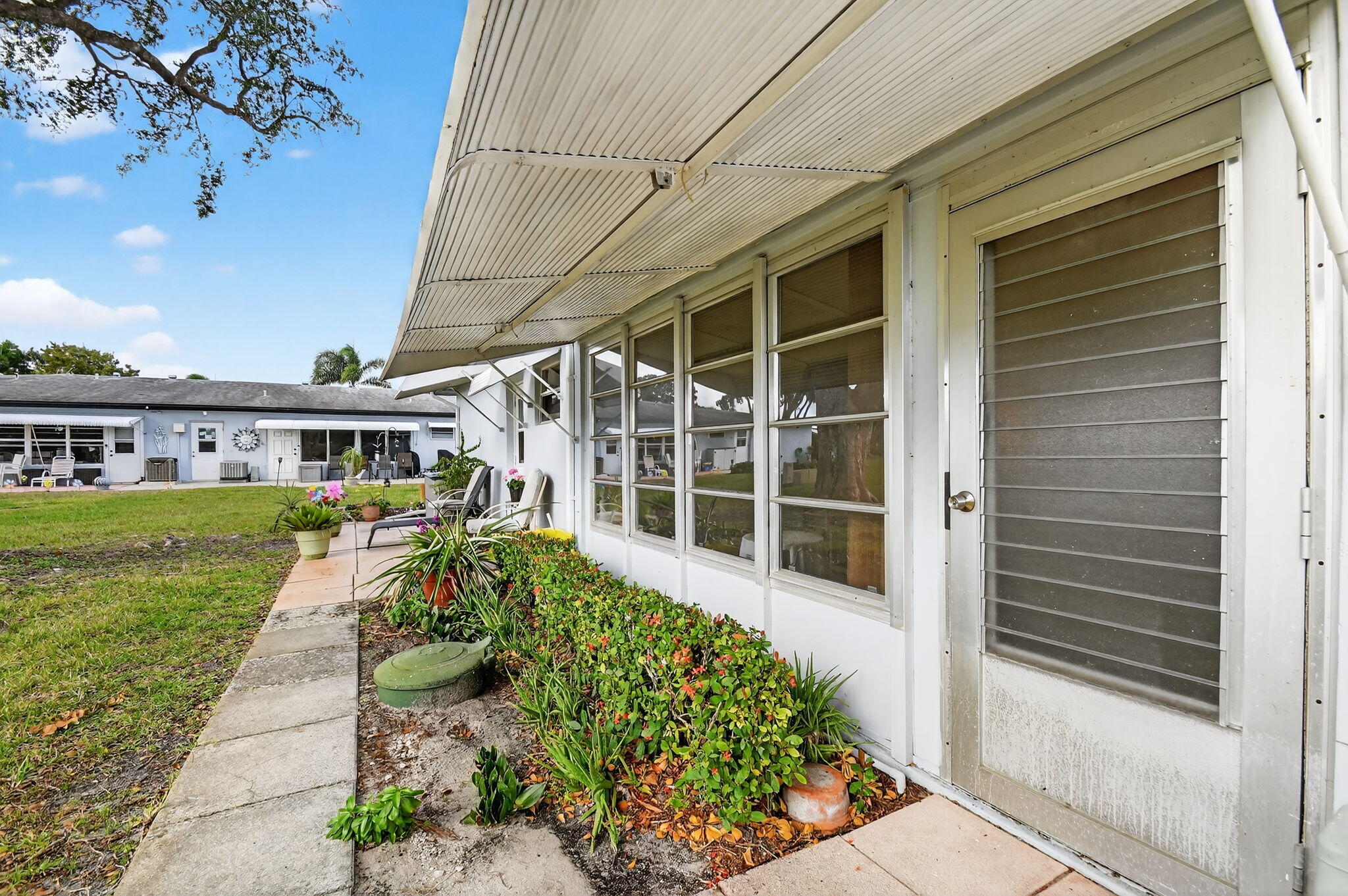 615 High Point Drive, Unit C Delray Beach, FL 33445 - Photo 35 of 48 a front view of a house with a yard