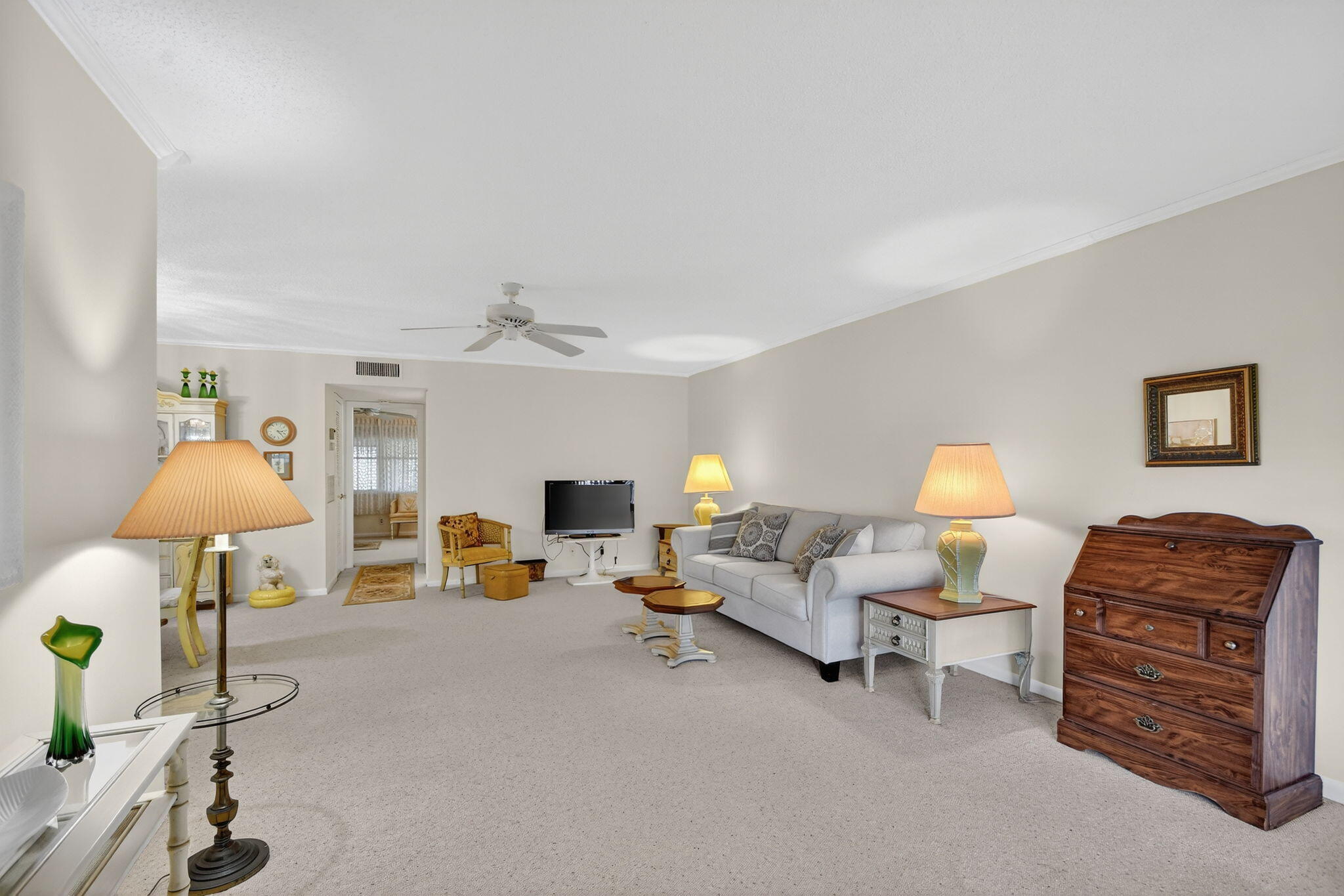 615 High Point Drive, Unit C Delray Beach, FL 33445 - Photo 6 of 48 a living room with furniture and a lamp