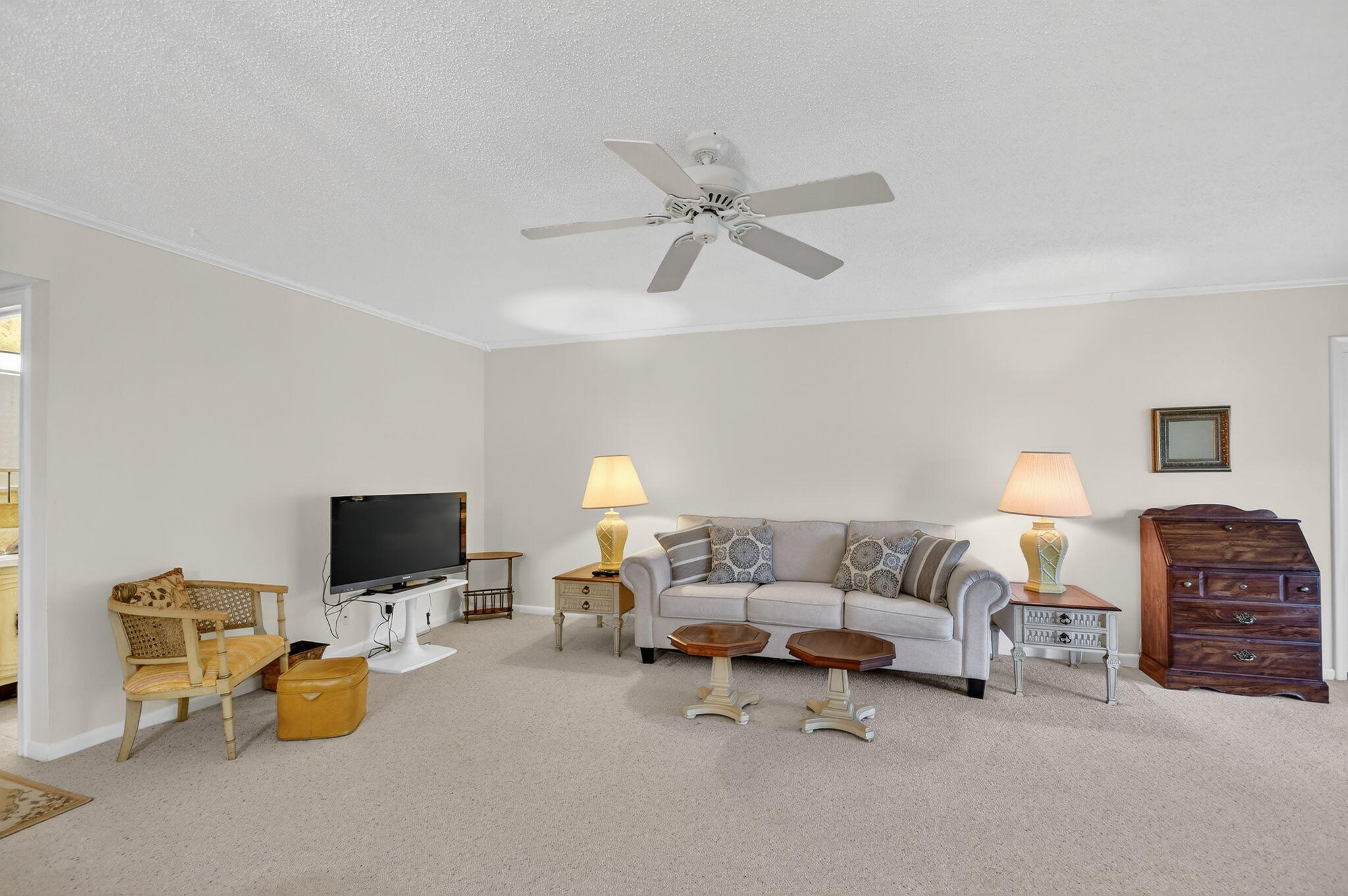 615 High Point Drive, Unit C Delray Beach, FL 33445 - Photo 9 of 48 a living room with furniture and a flat screen tv