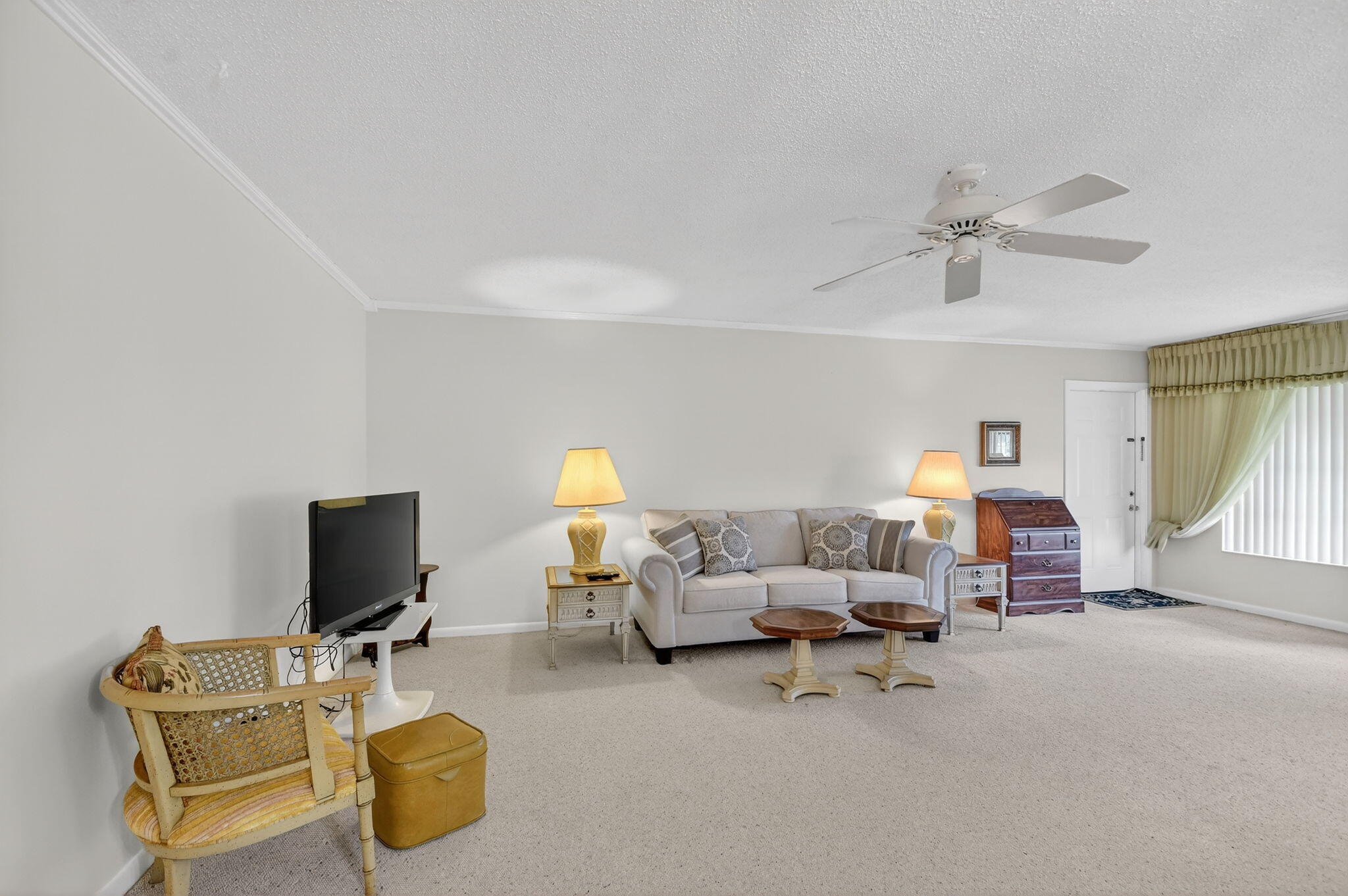 615 High Point Drive, Unit C Delray Beach, FL 33445 - Photo 10 of 48 a living room with furniture and a flat screen tv