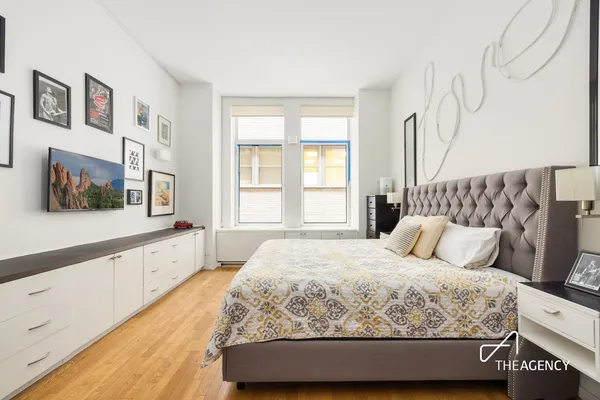 a bedroom with a large bed and a large window