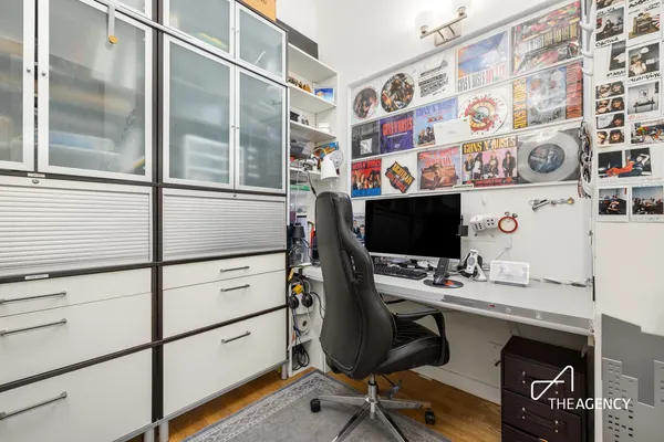 a view of a workspace with furniture and a window